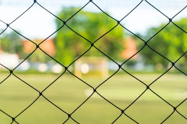 close-up net with soccer field background close-up net with soccer field background